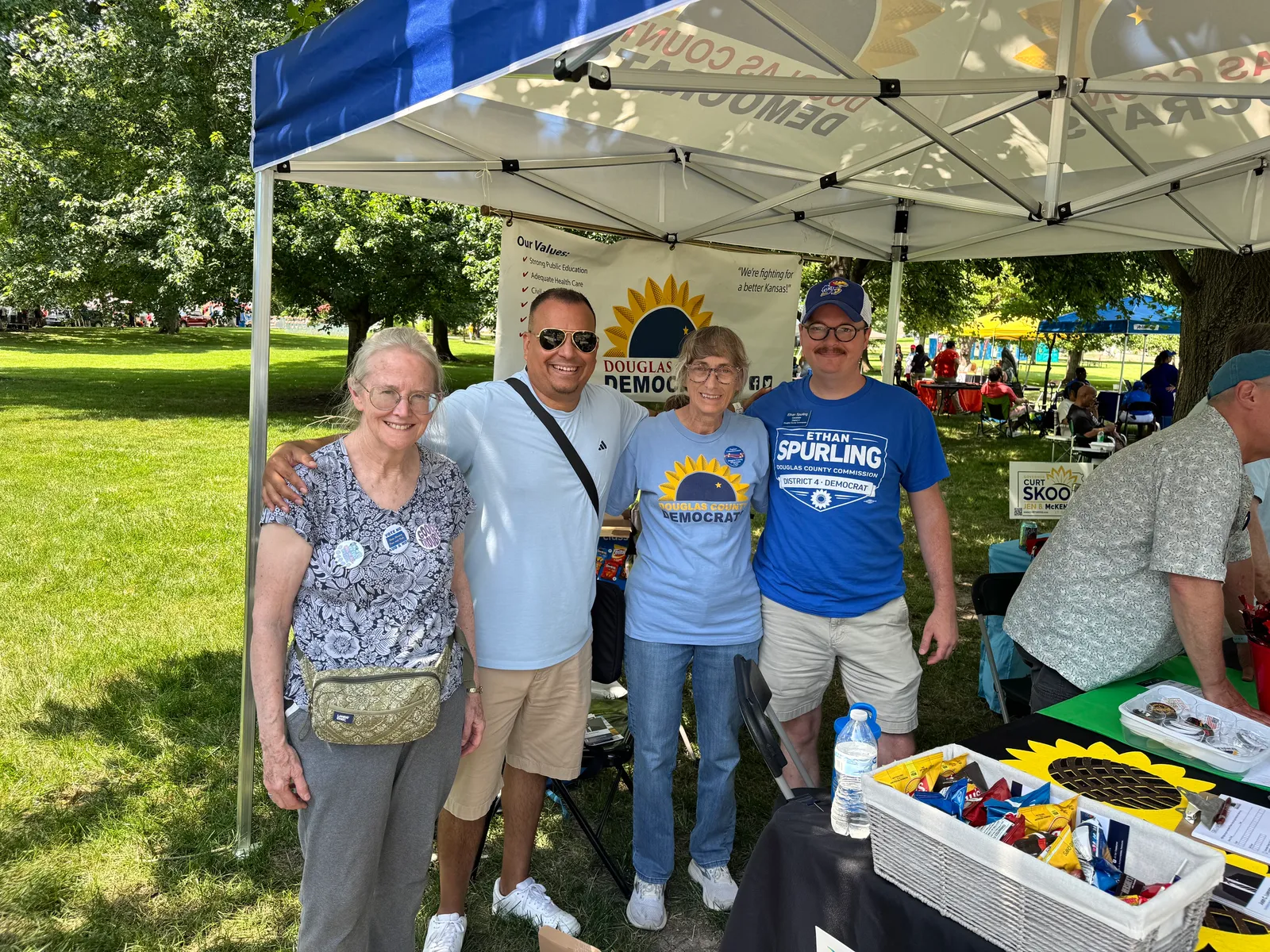 Juan C. Luengo with supporters at the Douglas County Democrats tent during a Juneteenth celebration in Lawrence, Kansas.
